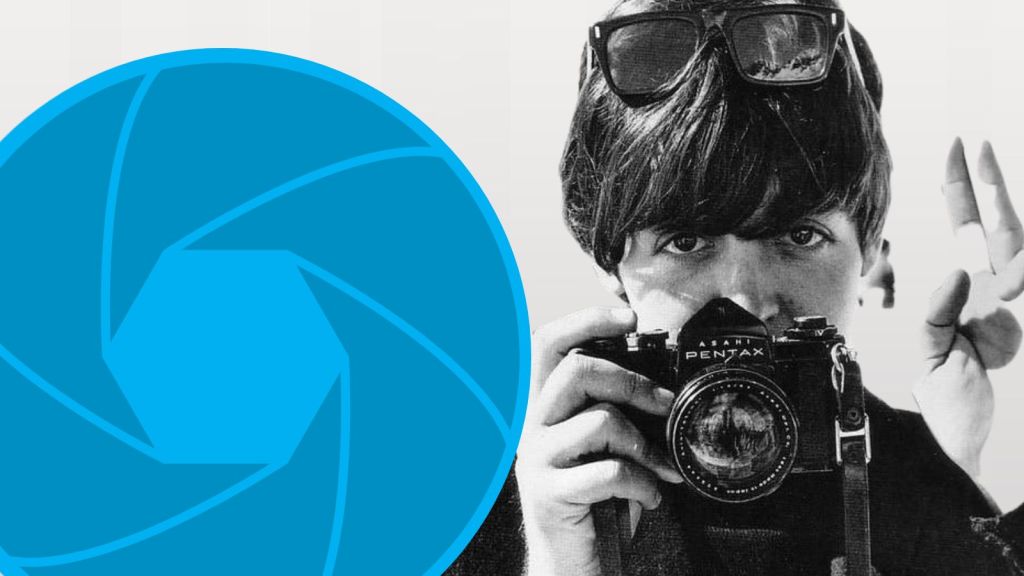 Paul McCartney holding a Pentax camera